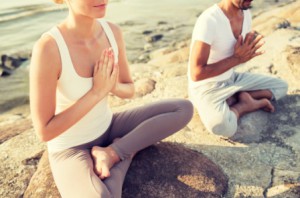 close up of couple making yoga exercises outdoors